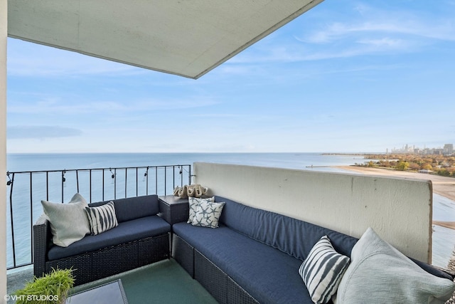 balcony with an outdoor hangout area and a water view