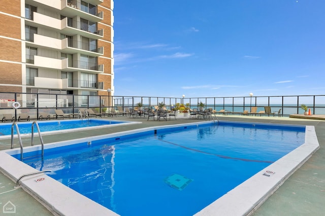 view of pool with a water view