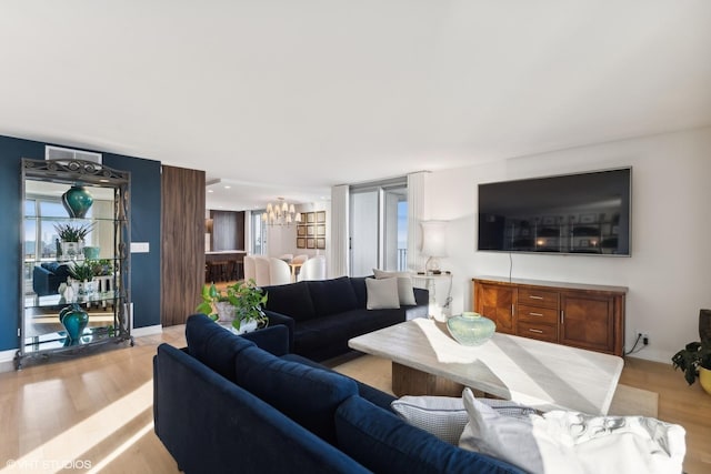 living room featuring an inviting chandelier and light hardwood / wood-style flooring