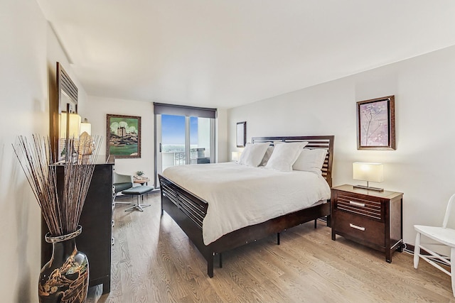 bedroom featuring access to outside and light hardwood / wood-style floors