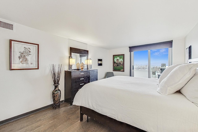 bedroom featuring hardwood / wood-style floors and access to outside