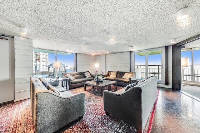 living room featuring a wall of windows and a textured ceiling