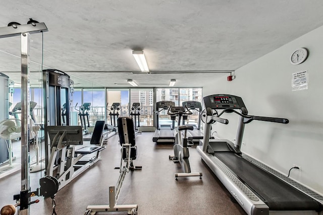 gym with floor to ceiling windows and plenty of natural light