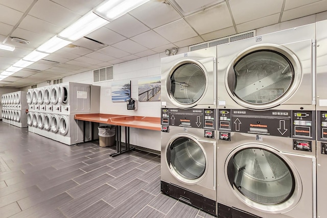 washroom with washing machine and dryer and stacked washer and clothes dryer