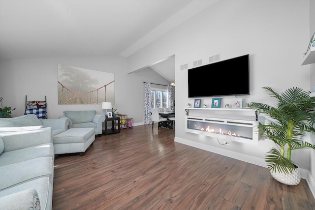 living room featuring dark wood-type flooring and vaulted ceiling