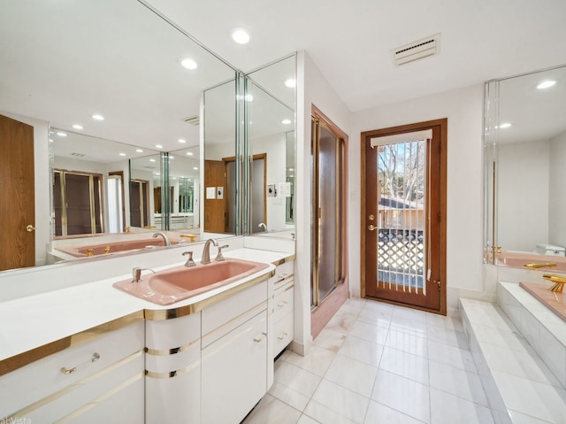 full bath featuring a garden tub, recessed lighting, visible vents, vanity, and tile patterned flooring