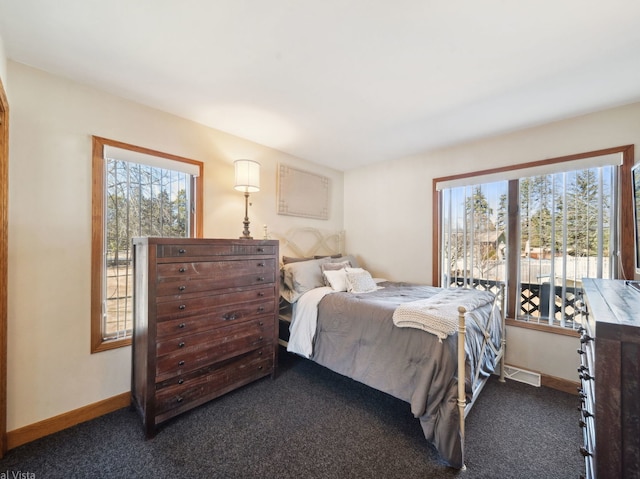 bedroom featuring baseboards, visible vents, and dark carpet