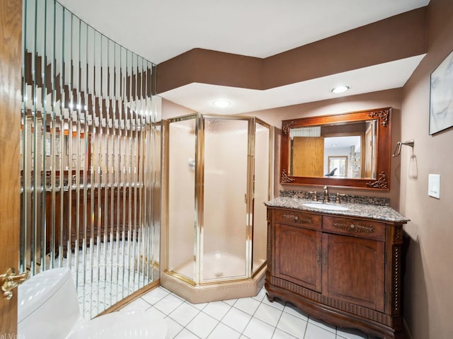 bathroom featuring toilet, a shower stall, and vanity