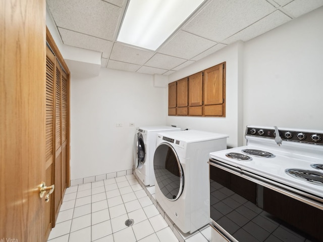 laundry room with laundry area, baseboards, and light tile patterned floors