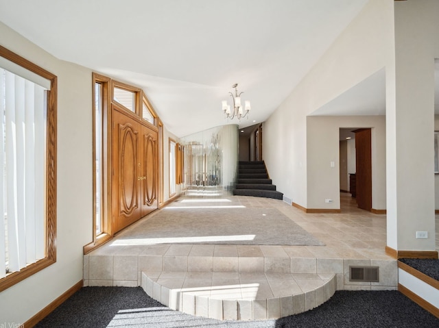 interior space with carpet, a notable chandelier, visible vents, vaulted ceiling, and baseboards