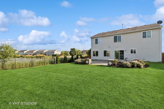 back of house with a patio and a yard