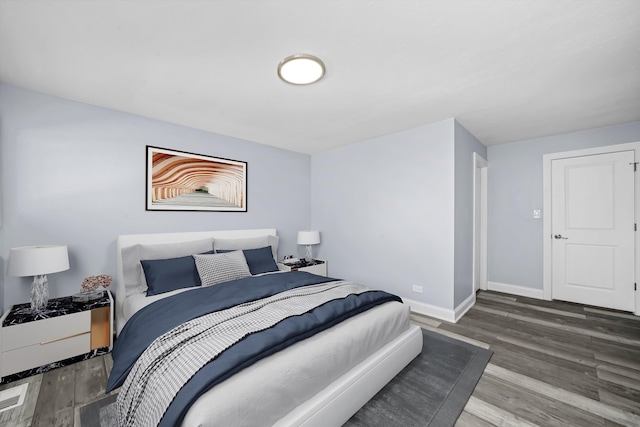 bedroom with dark wood-type flooring