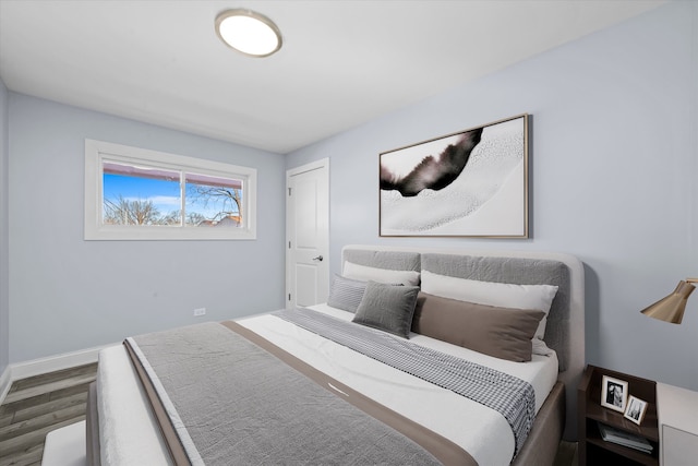 bedroom with dark hardwood / wood-style floors