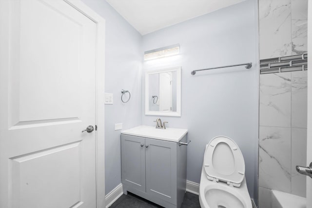 full bathroom featuring vanity, tiled shower / bath, and toilet