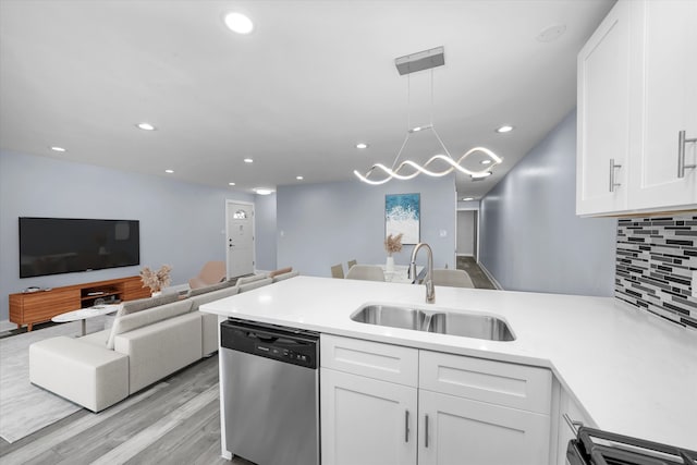 kitchen with white cabinetry, sink, decorative backsplash, and dishwasher