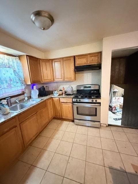 kitchen featuring sink, light tile patterned floors, and gas stove