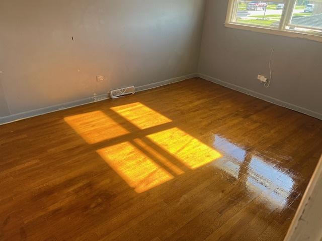 unfurnished room with hardwood / wood-style floors