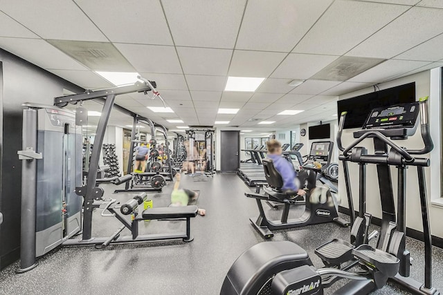 gym with a paneled ceiling