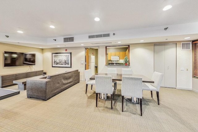 dining area featuring light colored carpet