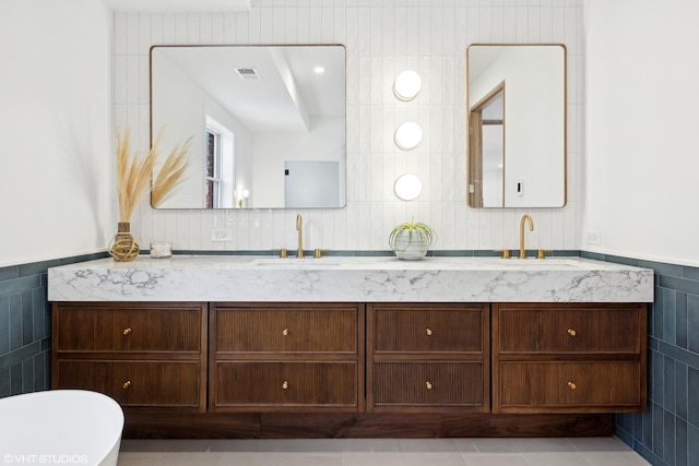 bathroom with vanity, tile patterned floors, and tile walls