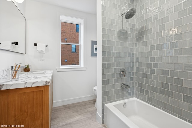 full bathroom featuring plenty of natural light, toilet, vanity, and tiled shower / bath combo