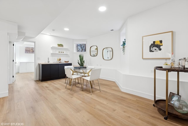 dining space featuring wood-type flooring