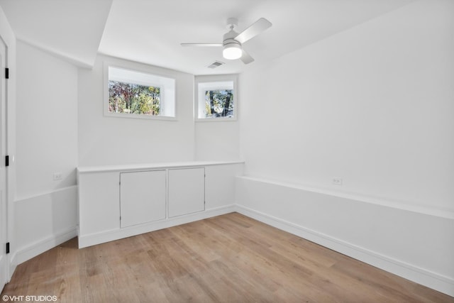 unfurnished room with light wood-type flooring and ceiling fan