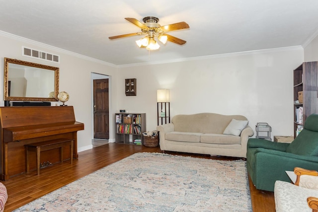 living room featuring hardwood / wood-style flooring, ornamental molding, and ceiling fan