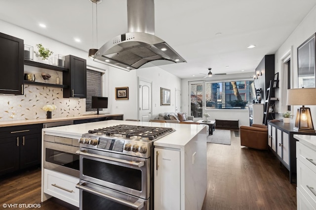 kitchen with decorative light fixtures, double oven range, dark hardwood / wood-style flooring, island exhaust hood, and white cabinets