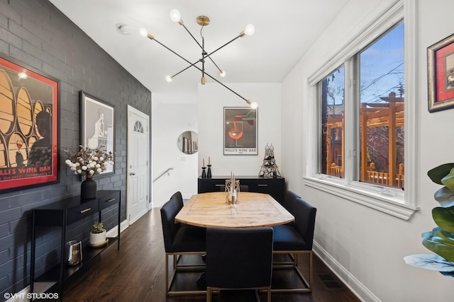 dining area with a notable chandelier and dark wood-type flooring