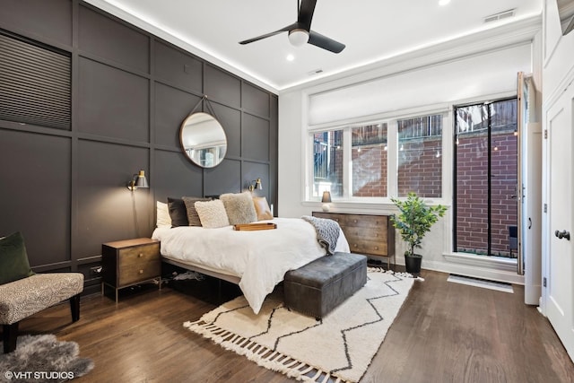 bedroom with dark hardwood / wood-style floors and ceiling fan