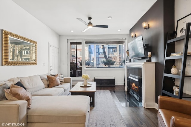 living room with dark hardwood / wood-style floors and ceiling fan