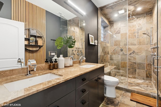 bathroom featuring vanity, toilet, and a shower with door