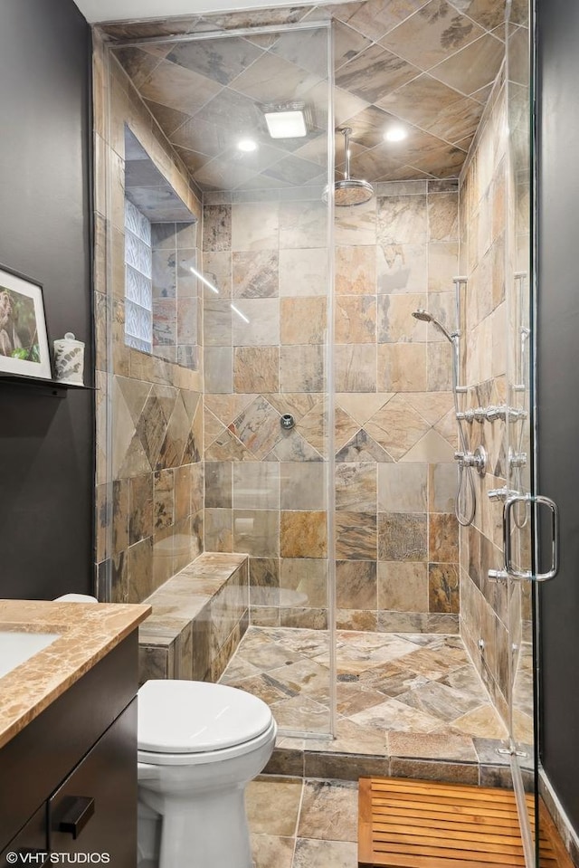 bathroom with vanity, toilet, and an enclosed shower