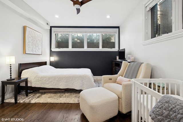 bedroom with dark wood-type flooring and ceiling fan