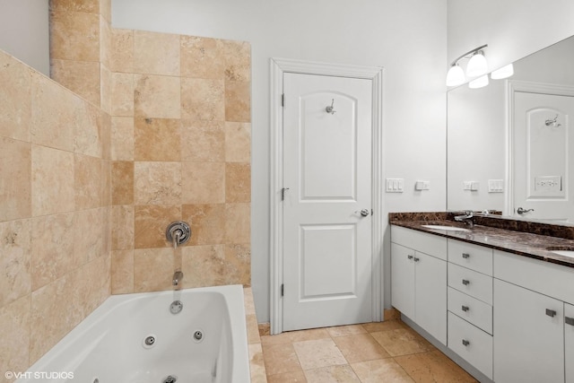 bathroom featuring tiled shower / bath and vanity