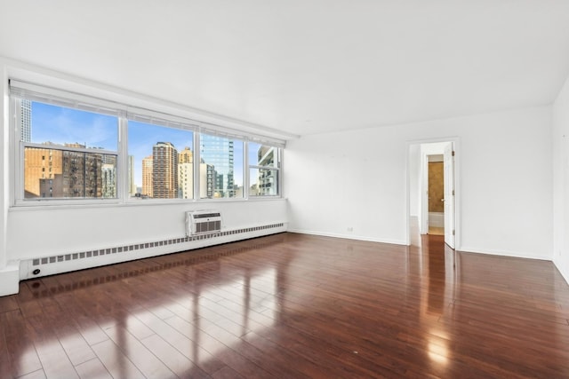 unfurnished room with dark hardwood / wood-style flooring, a wall mounted AC, and baseboard heating