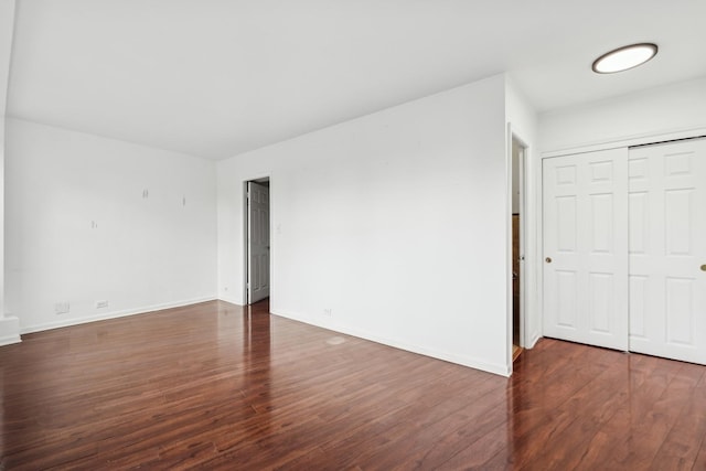 unfurnished room with dark hardwood / wood-style floors