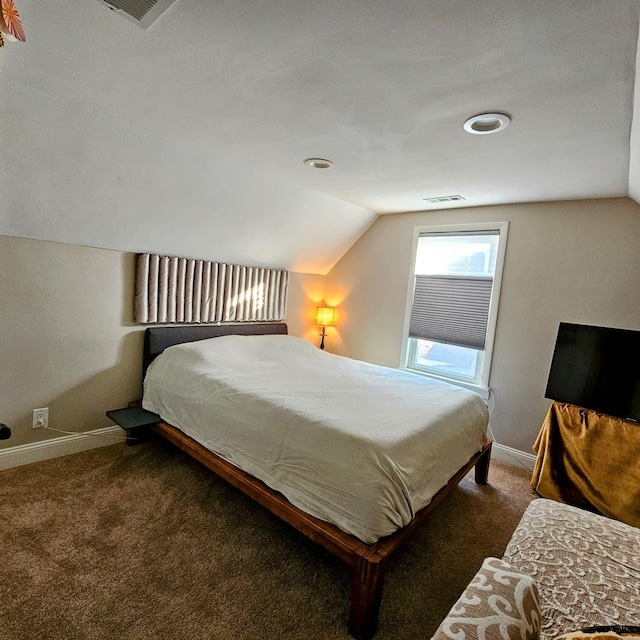 carpeted bedroom with vaulted ceiling