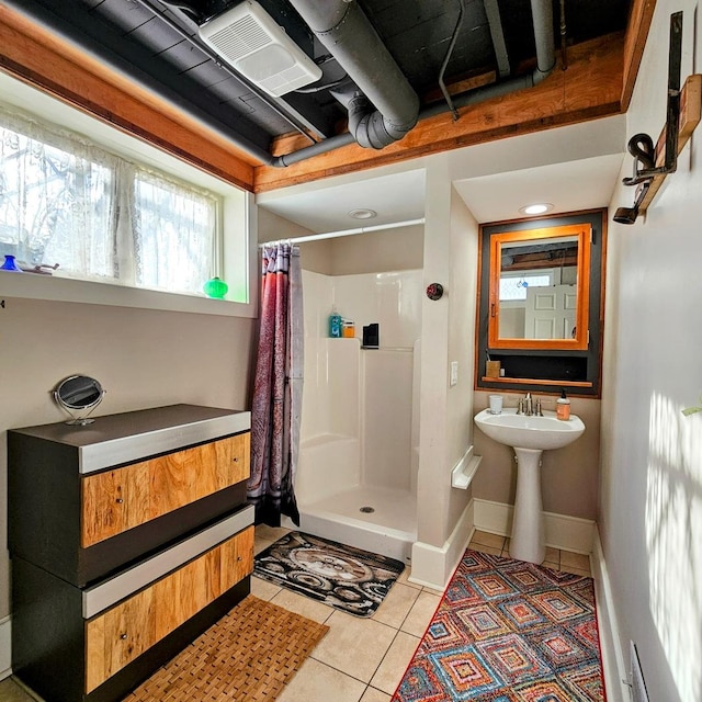 bathroom featuring curtained shower and tile patterned floors