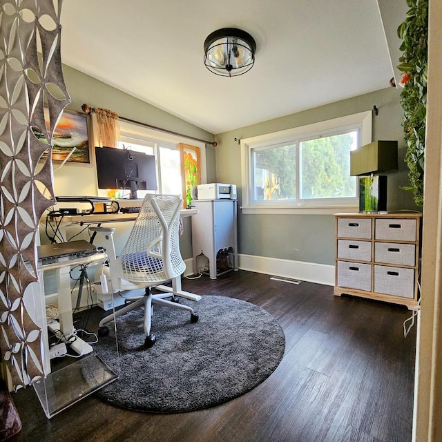 office with dark hardwood / wood-style flooring and lofted ceiling