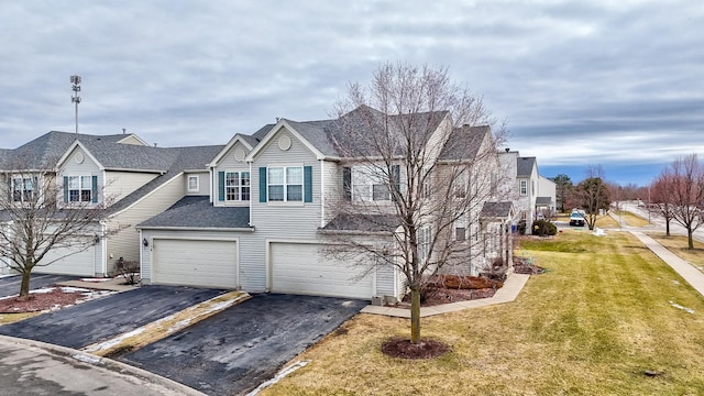 view of front of home with a garage and a front lawn