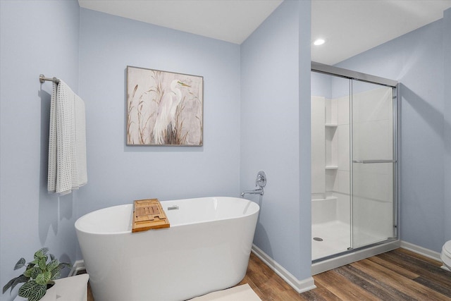 bathroom with wood-type flooring and separate shower and tub