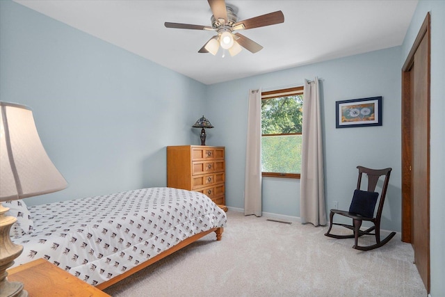 carpeted bedroom featuring a closet and ceiling fan