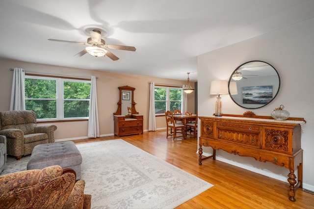 living room with light hardwood / wood-style floors and ceiling fan