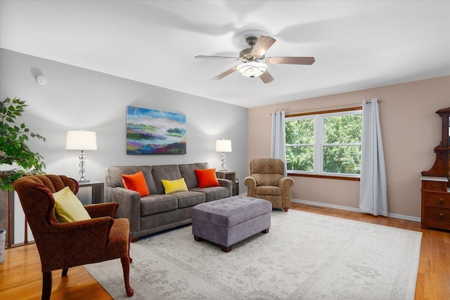 living room featuring light hardwood / wood-style floors and ceiling fan