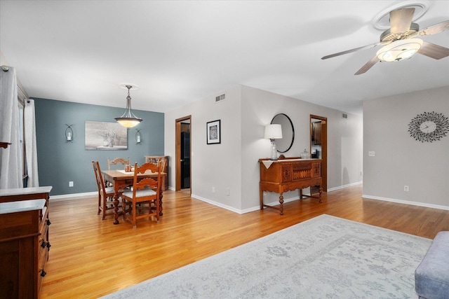 dining space featuring hardwood / wood-style flooring and ceiling fan