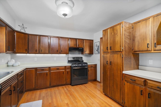 kitchen featuring range with gas stovetop and light hardwood / wood-style flooring