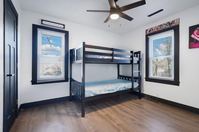 unfurnished bedroom with dark hardwood / wood-style flooring and ceiling fan