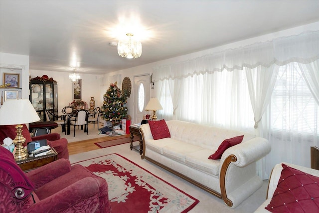 living room featuring hardwood / wood-style floors, a healthy amount of sunlight, and a notable chandelier